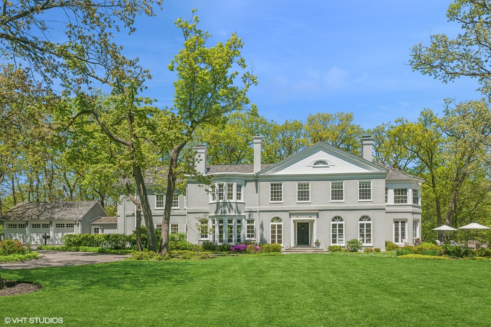 855 Sheridan Road Highland Park, IL 60035 - Photo 60 of 62 a front view of a house with a garden