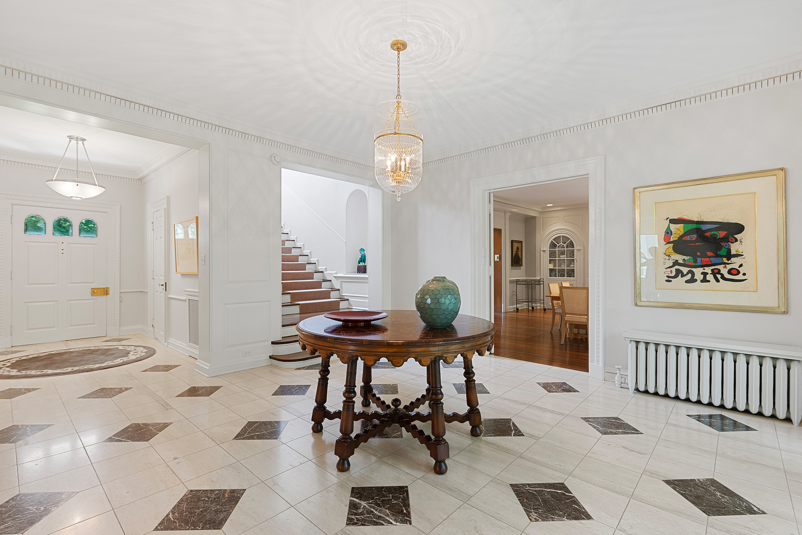 855 Sheridan Road Highland Park, IL 60035 - Photo 6 of 62 a view of a hallway with dining area table and chairs