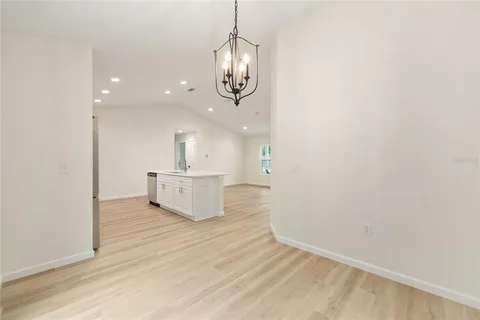 a view of a room with wooden floor and white walls