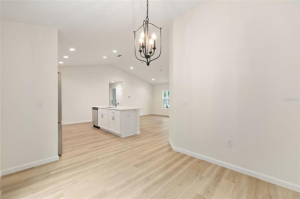 14769 Southwest 24th Place Ocala, FL 34481 - Photo 13 of 33 a view of a room with wooden floor and white walls