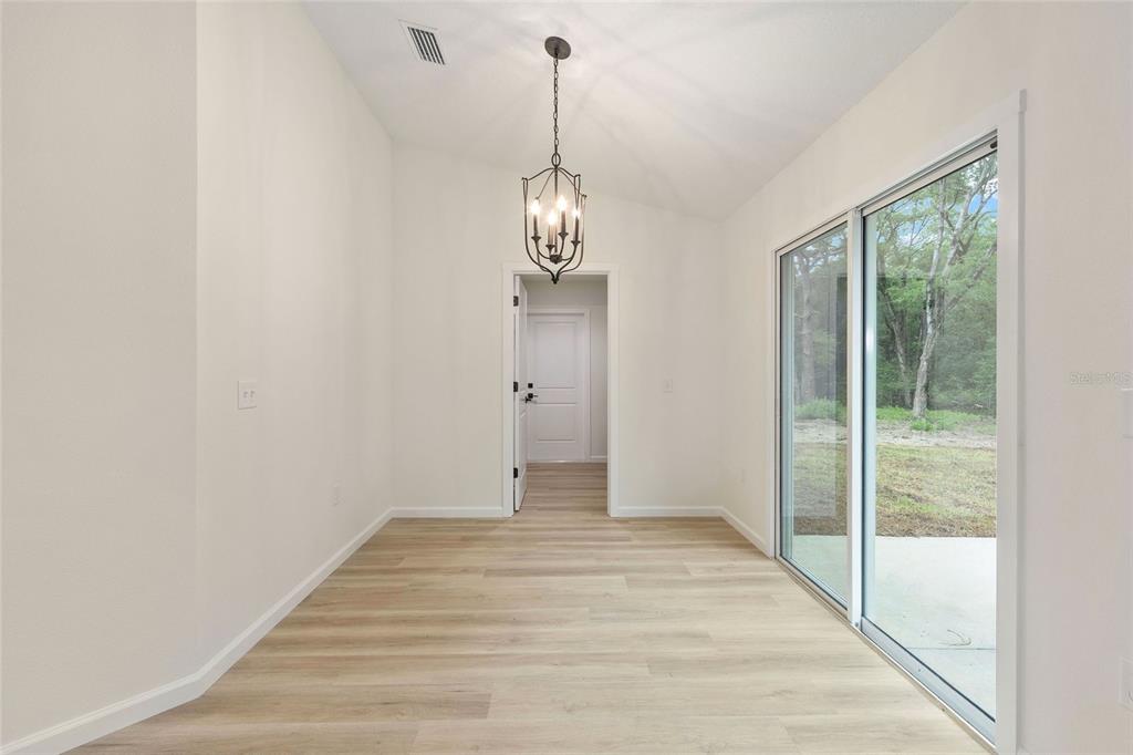 14769 Southwest 24th Place Ocala, FL 34481 - Photo 15 of 33 a view of empty room with wooden floor and fan