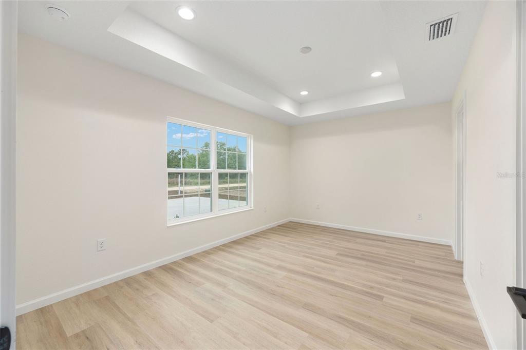 14769 Southwest 24th Place Ocala, FL 34481 - Photo 17 of 33 an empty room with wooden floor and windows