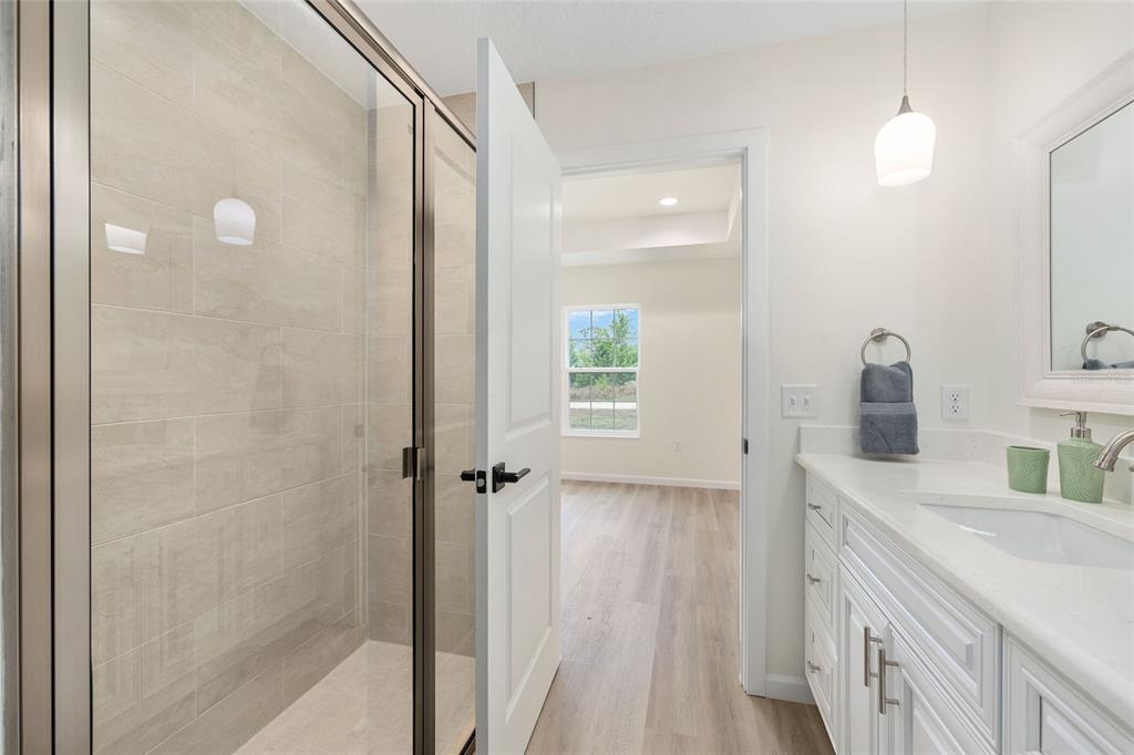 14769 Southwest 24th Place Ocala, FL 34481 - Photo 20 of 33 a bathroom with a double vanity sink a mirror and a shower