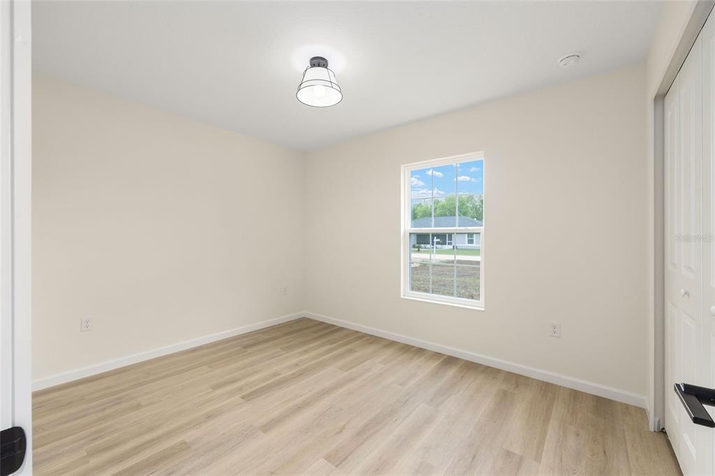 14769 Southwest 24th Place Ocala, FL 34481 - Photo 21 of 33 an empty room with wooden floor and windows