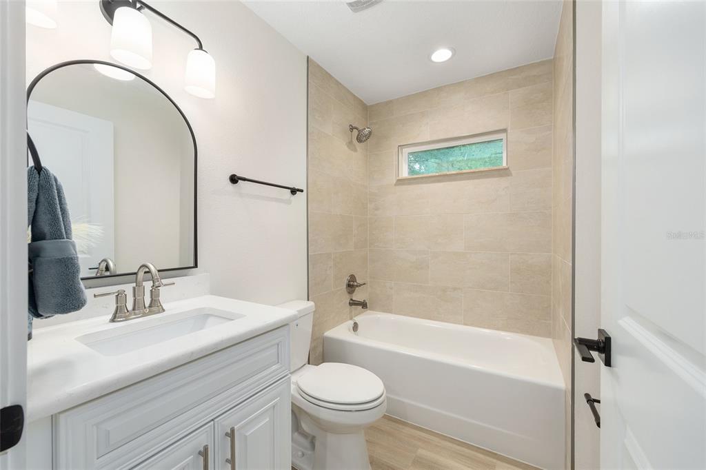 14769 Southwest 24th Place Ocala, FL 34481 - Photo 23 of 33 a bathroom with a sink a toilet and a mirror