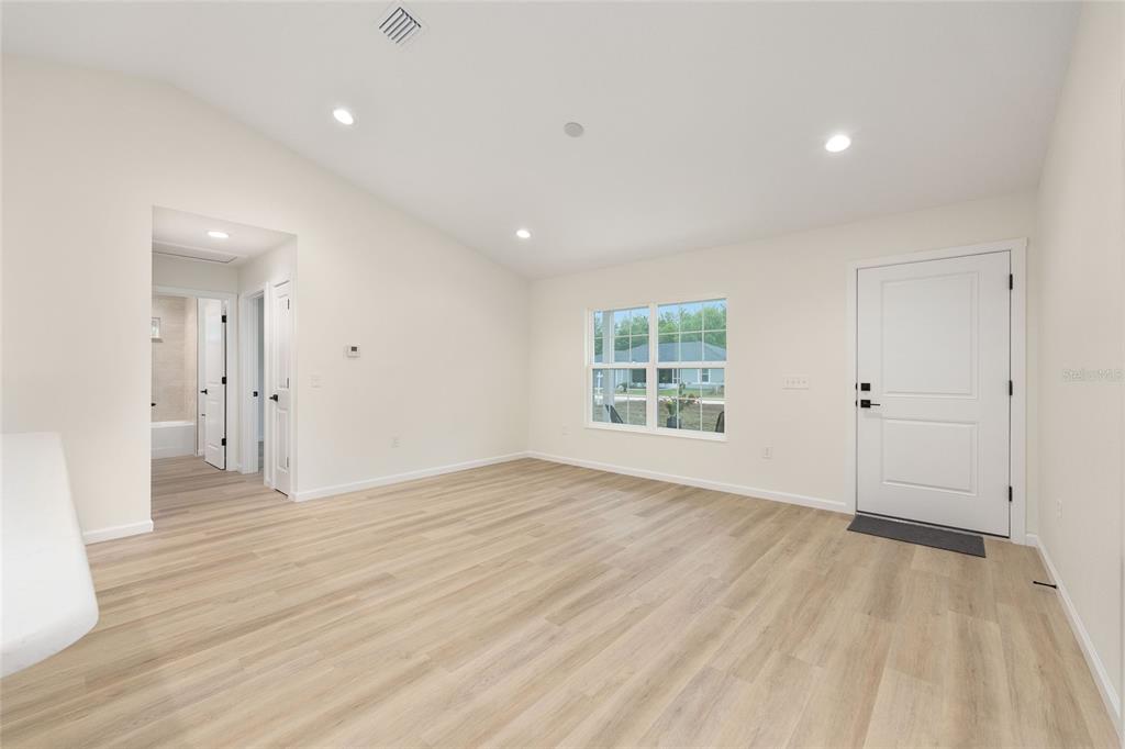 14769 Southwest 24th Place Ocala, FL 34481 - Photo 5 of 33 wooden floor in an empty room with a window