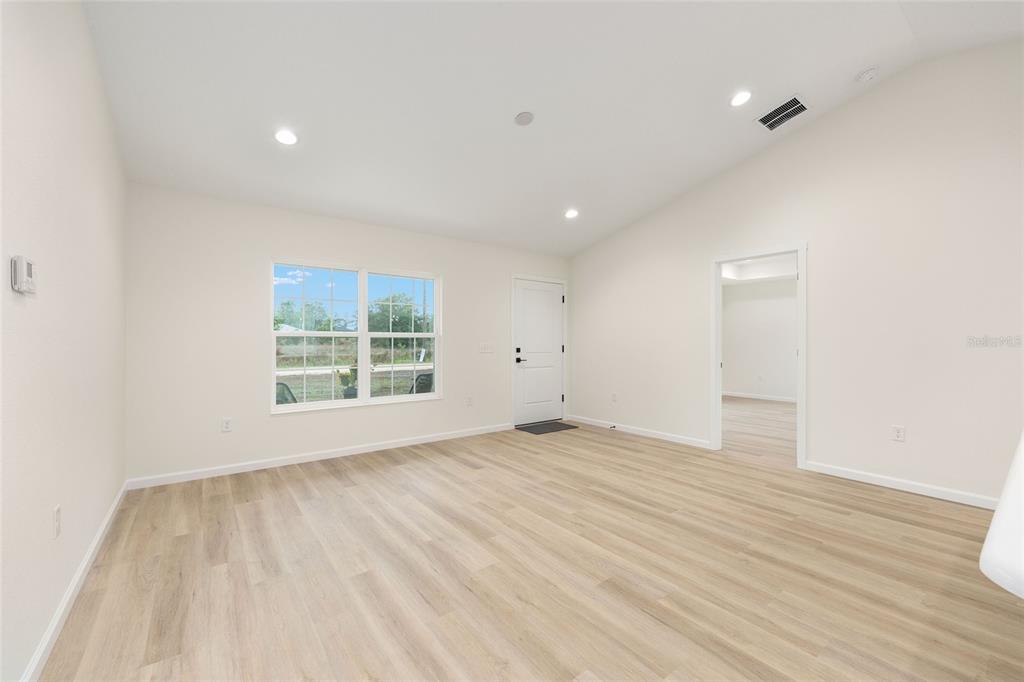 14769 Southwest 24th Place Ocala, FL 34481 - Photo 6 of 33 wooden floor in an empty room with a window