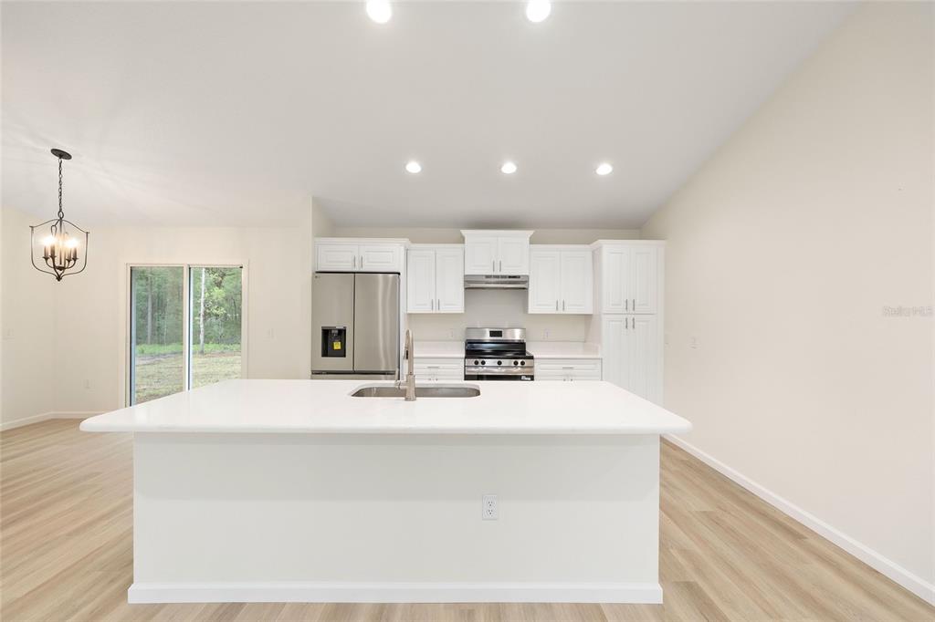 14769 Southwest 24th Place Ocala, FL 34481 - Photo 7 of 33 a kitchen with kitchen island sink stove and refrigerator