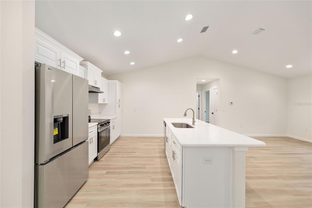 14769 Southwest 24th Place Ocala, FL 34481 - Photo 10 of 33 a large white kitchen with a sink and stainless steel appliances