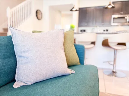 a dining room with furniture a large window and a chandelier