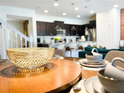 a dining room with furniture a rug and a flat screen tv