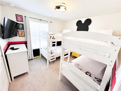 a kitchen with a sink a stove and a wooden floor