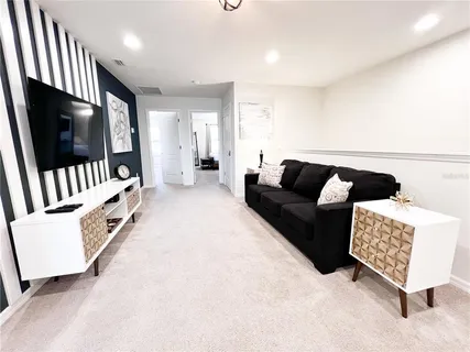 a bedroom with a bed window and a television