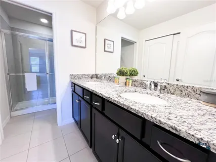 a large bed sitting in a bedroom next to a window