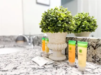 a white bed sitting in a bedroom next to a window
