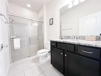 a kitchen with a stove a refrigerator and cabinets