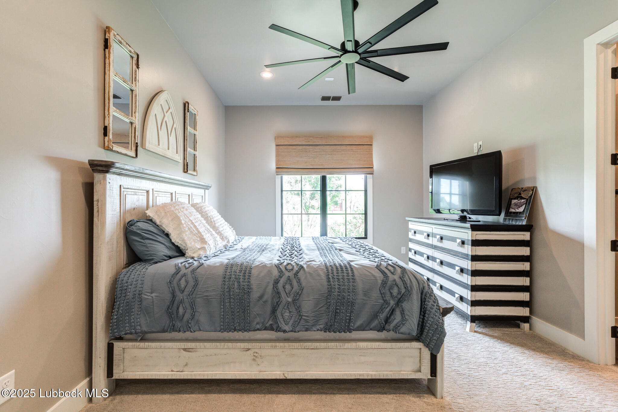 5004 County Road 7640 Lubbock, TX 79424 - Photo 24 of 79 a bedroom with a bed and a chandelier