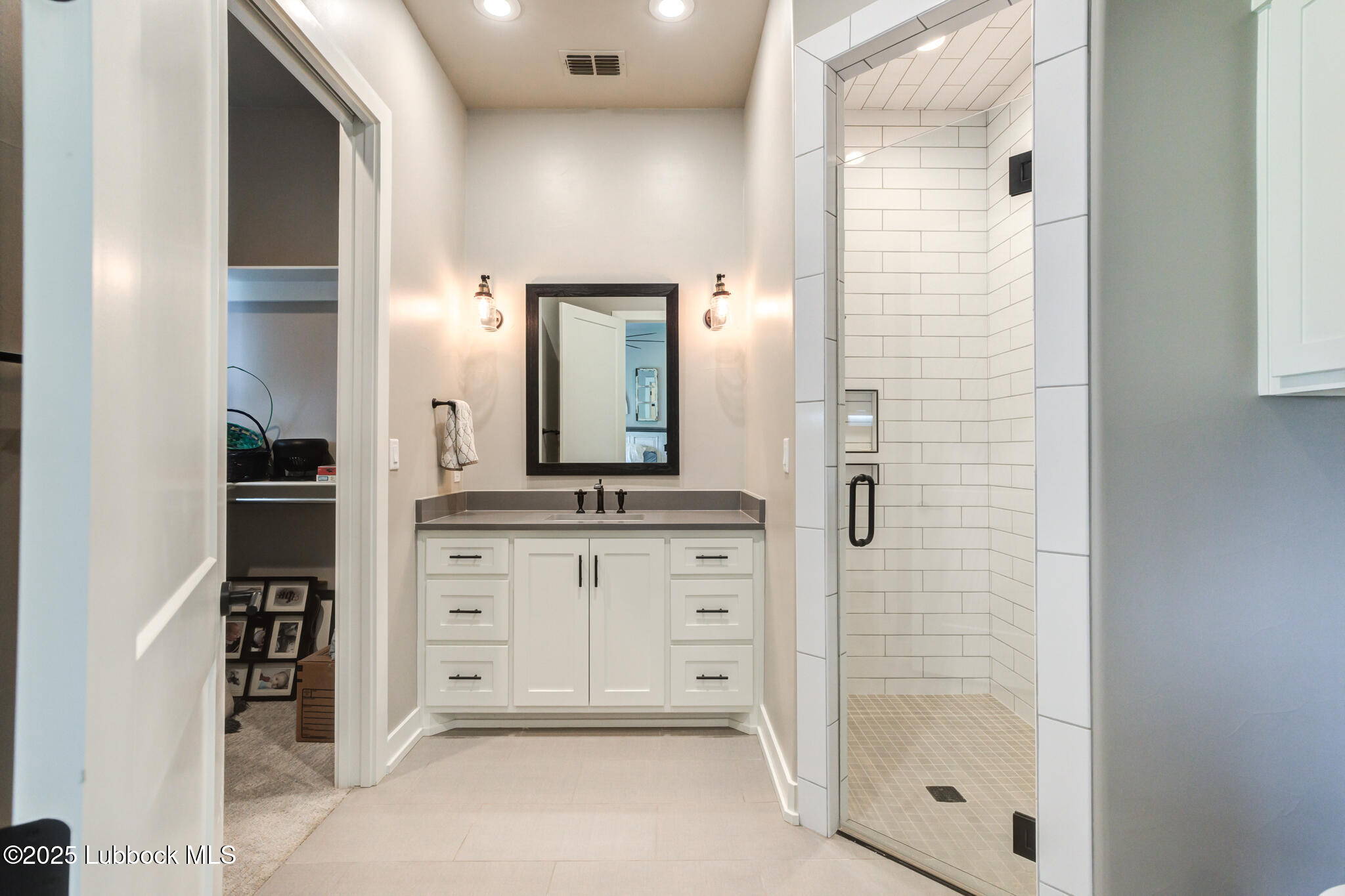 5004 County Road 7640 Lubbock, TX 79424 - Photo 26 of 79 a spacious bathroom with a shower sink and mirror