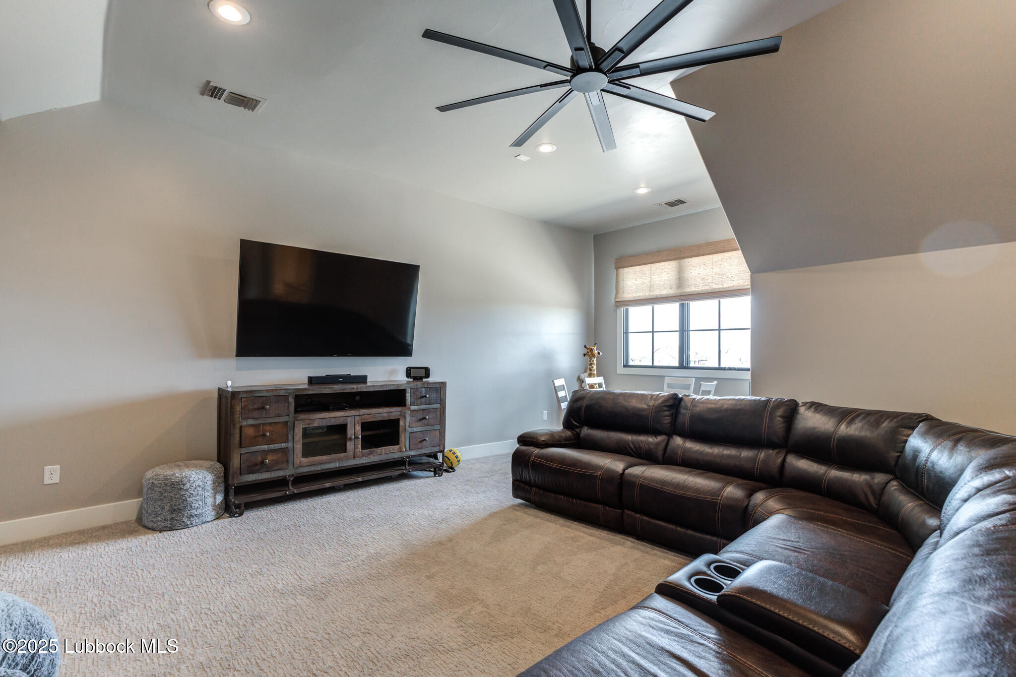 5004 County Road 7640 Lubbock, TX 79424 - Photo 32 of 79 a living room with furniture and a flat screen tv