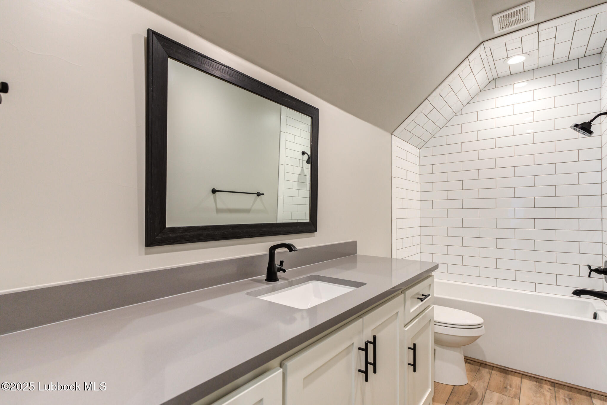 5004 County Road 7640 Lubbock, TX 79424 - Photo 37 of 79 a bathroom with a granite countertop sink a toilet and mirror