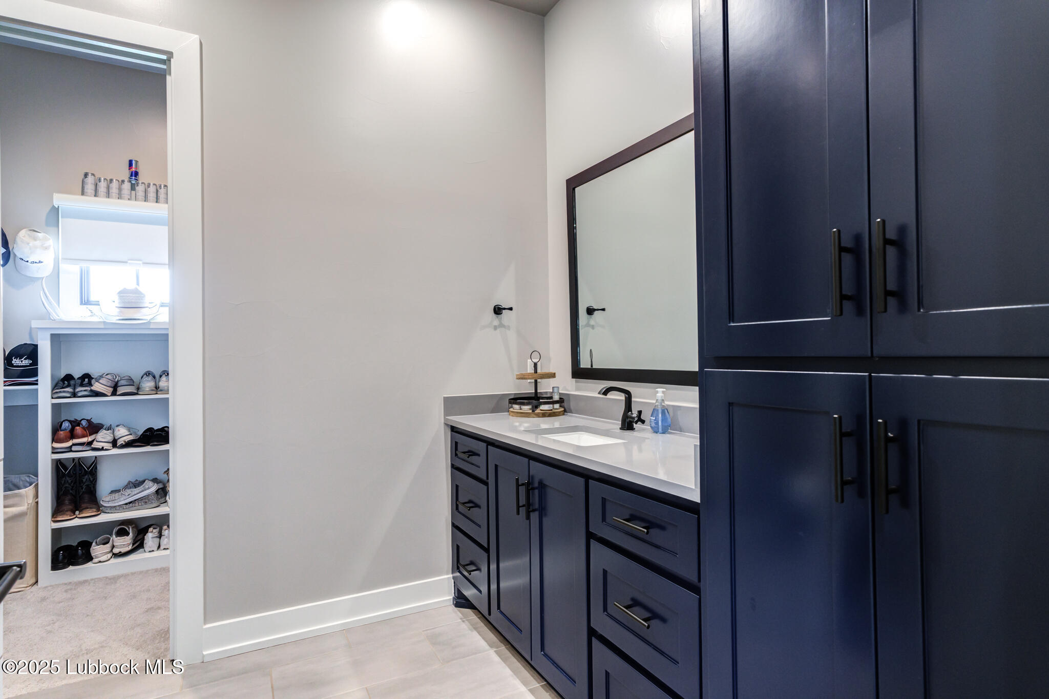 5004 County Road 7640 Lubbock, TX 79424 - Photo 45 of 79 a bathroom with a sink and a mirror