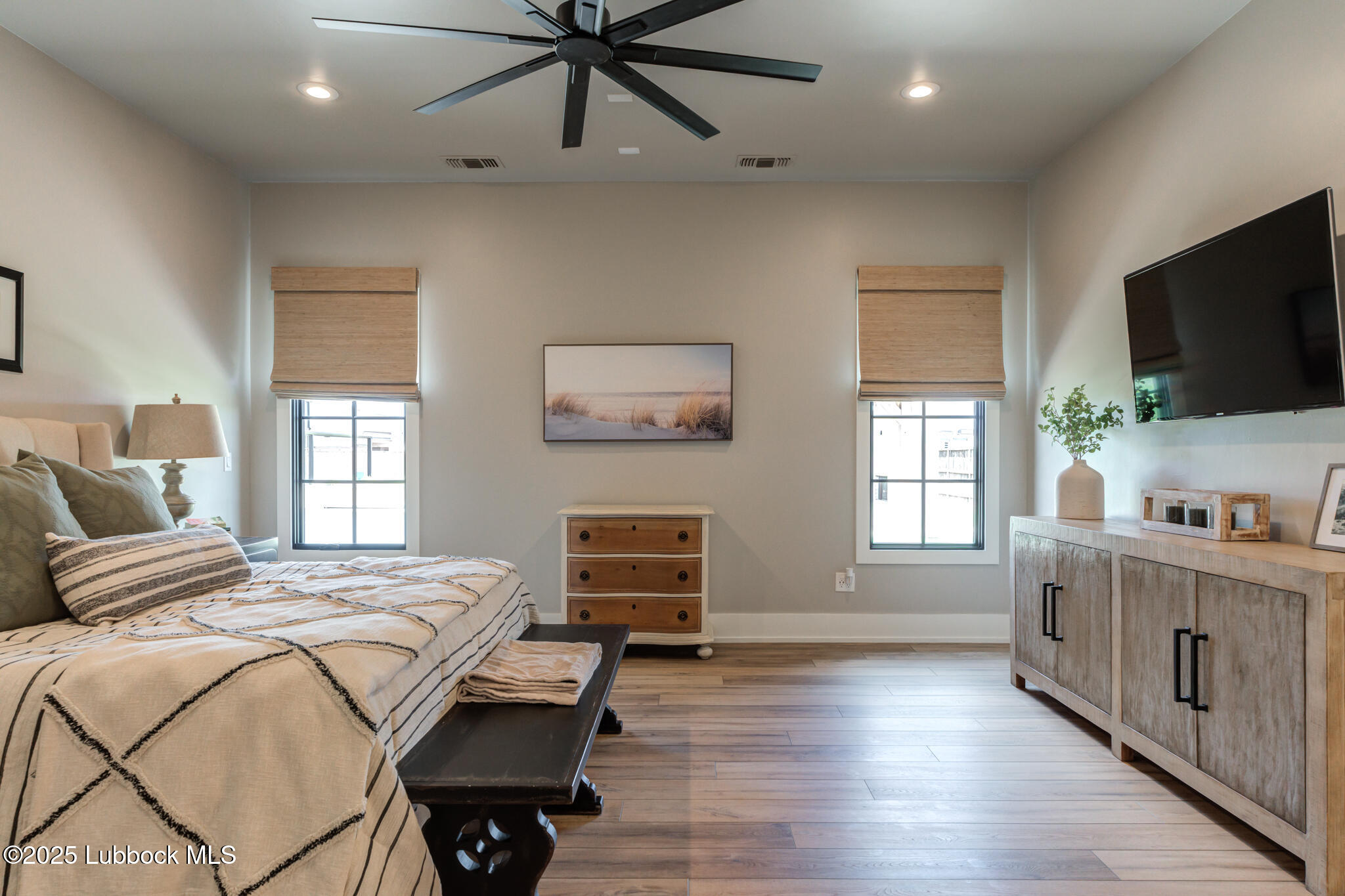 5004 County Road 7640 Lubbock, TX 79424 - Photo 49 of 79 a bedroom with a bed and a flat screen tv