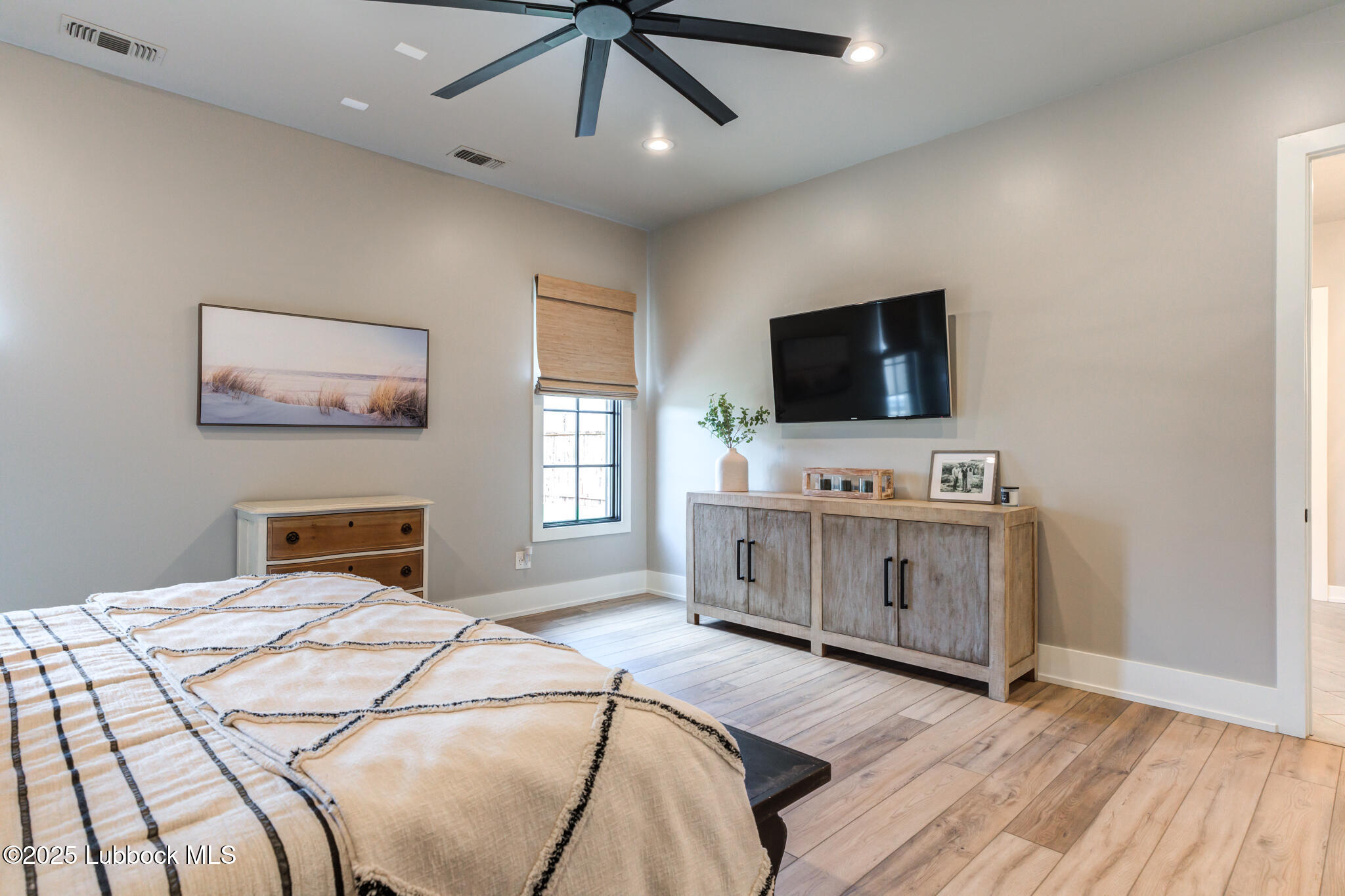 5004 County Road 7640 Lubbock, TX 79424 - Photo 50 of 79 a bedroom with a bed and a flat screen tv