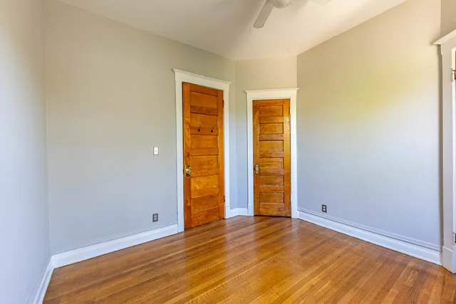 an empty room with wooden floor and closet