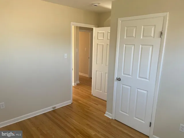 an empty room with wooden floor