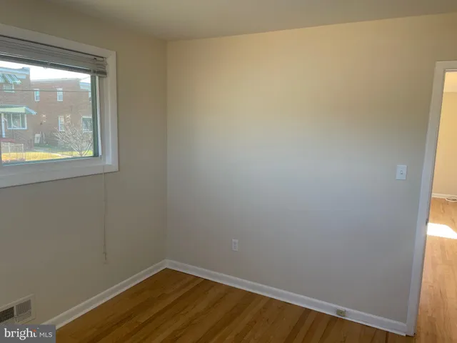a view of small space with wooden floor and windows