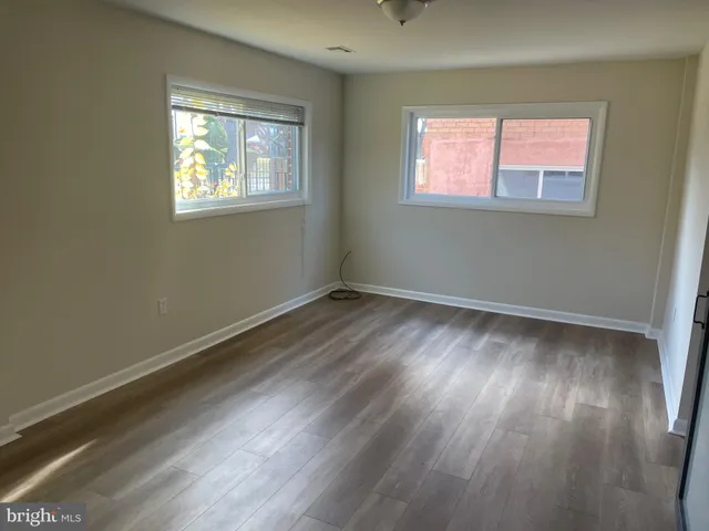 a view of room with hardwood floor and window