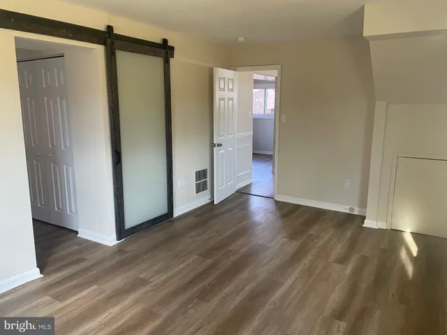 a view of hallway with wooden floor