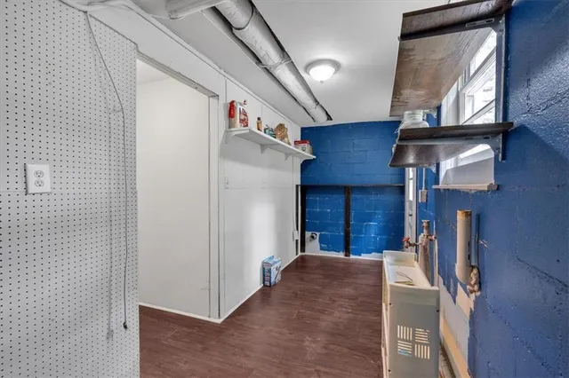 a view of a white house that has a tree in it