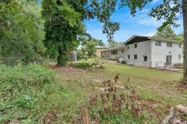an aerial view of a residential houses with yard and swimming pool