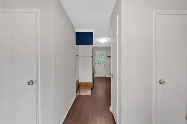 a bathroom with a toilet a sink and wooden cabinets