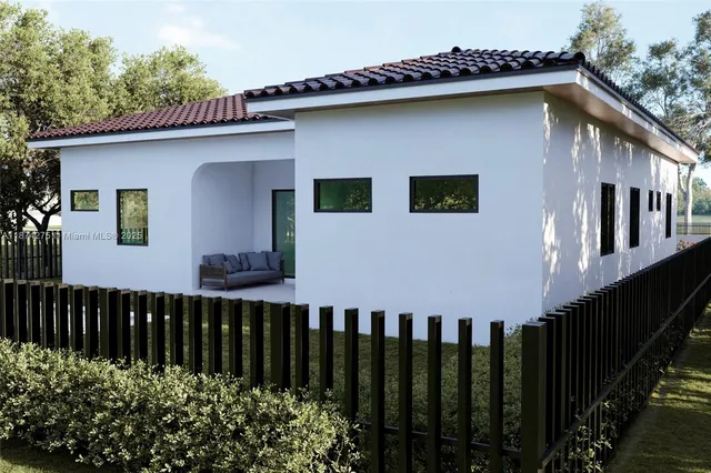 a front view of a house with wooden fence