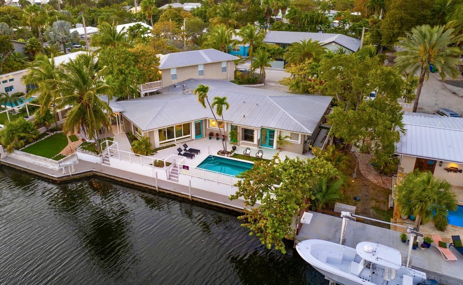 3446 Riviera Drive Key West, FL 33040 - Photo 1 of 73 a aerial view of a house with swimming pool patio and lake view
