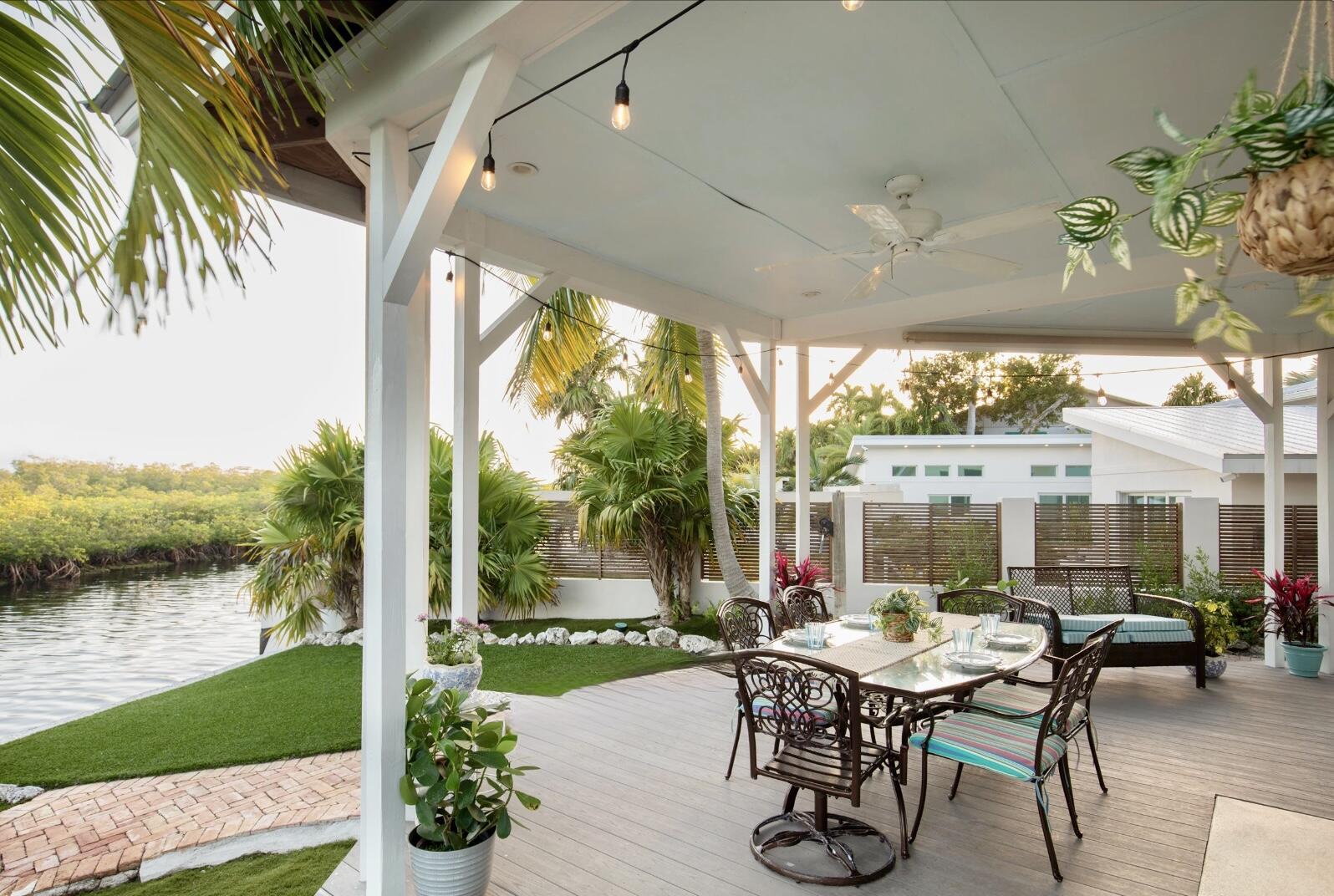 3446 Riviera Drive Key West, FL 33040 - Photo 11 of 73 a view of a patio with a table chairs and a table