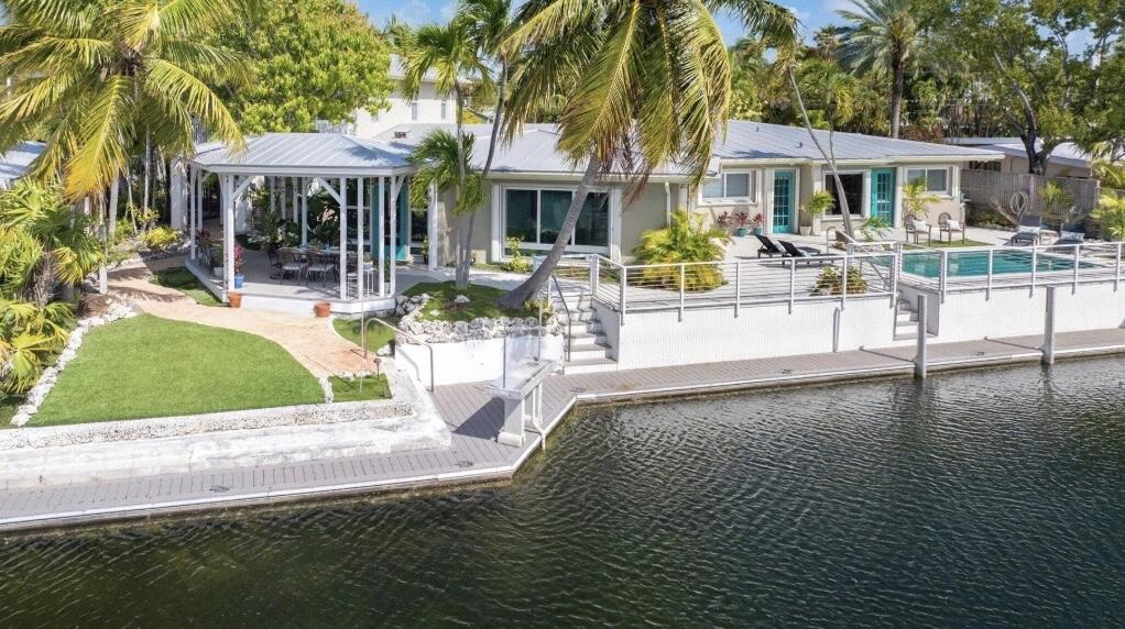 3446 Riviera Drive Key West, FL 33040 - Photo 3 of 73 a view of a house with dining room and swimming pool