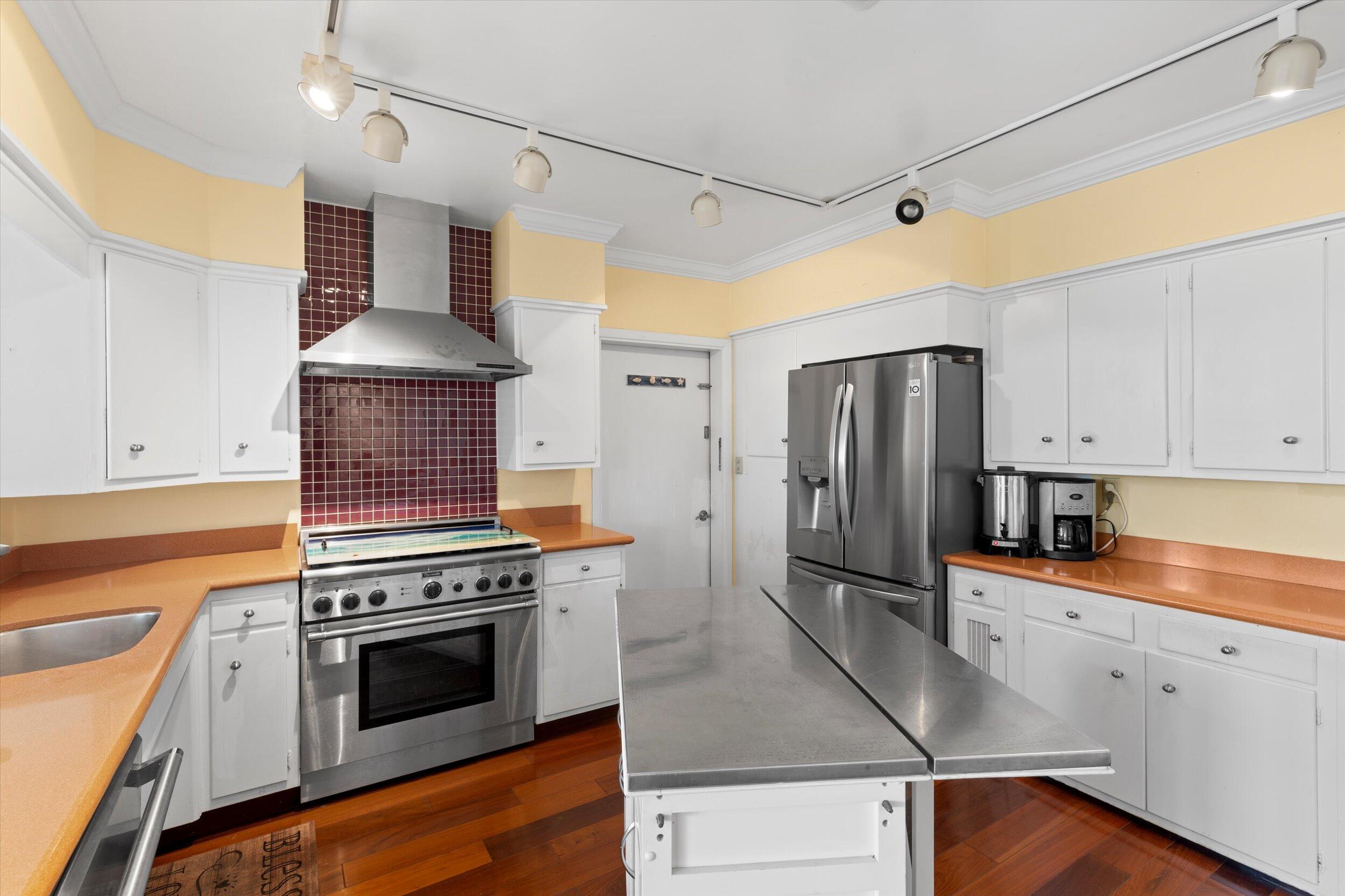 3446 Riviera Drive Key West, FL 33040 - Photo 31 of 73 a kitchen with a stove a refrigerator and a sink