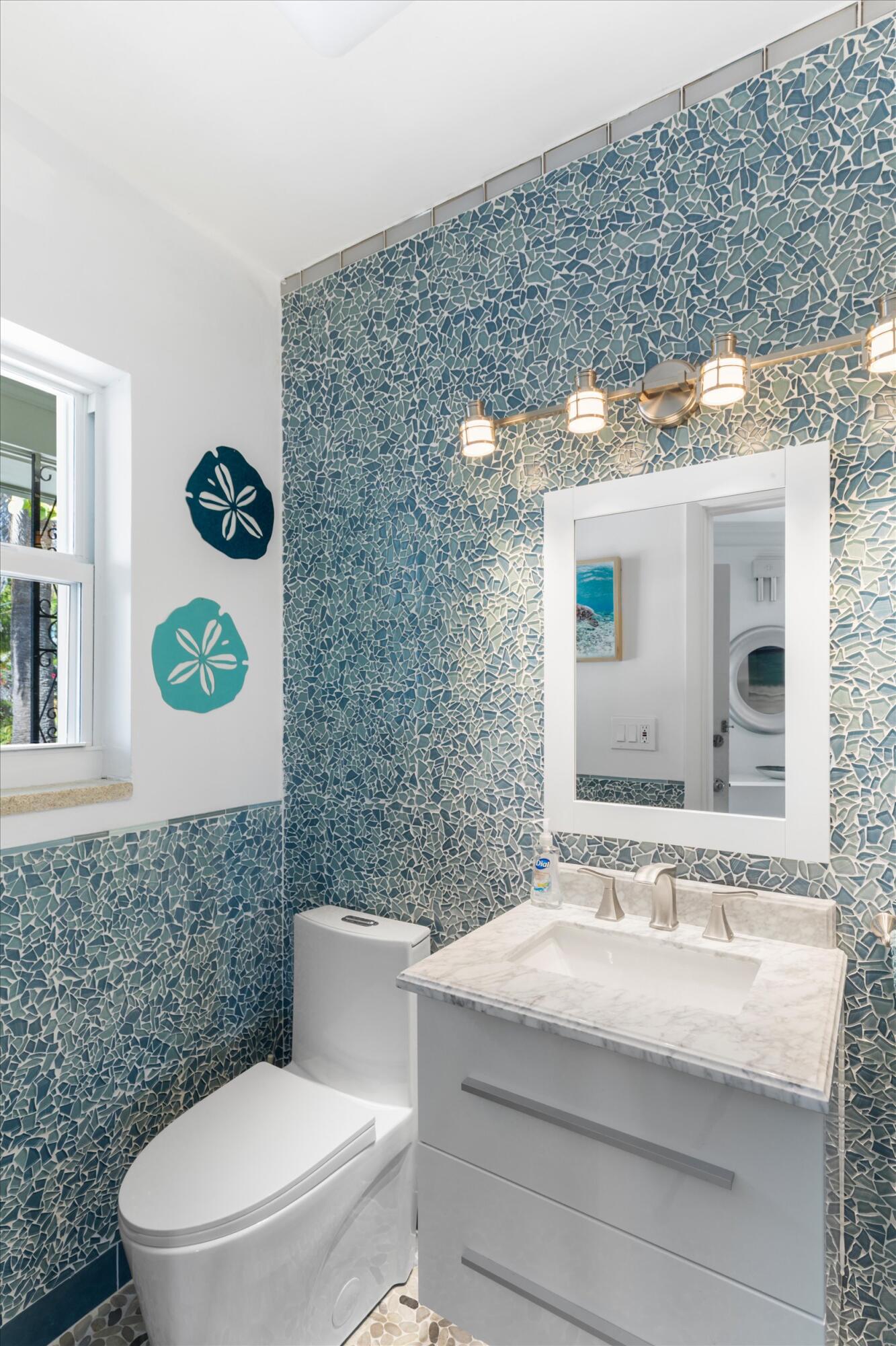 3446 Riviera Drive Key West, FL 33040 - Photo 36 of 73 a bathroom with a sink mirror vanity and toilet