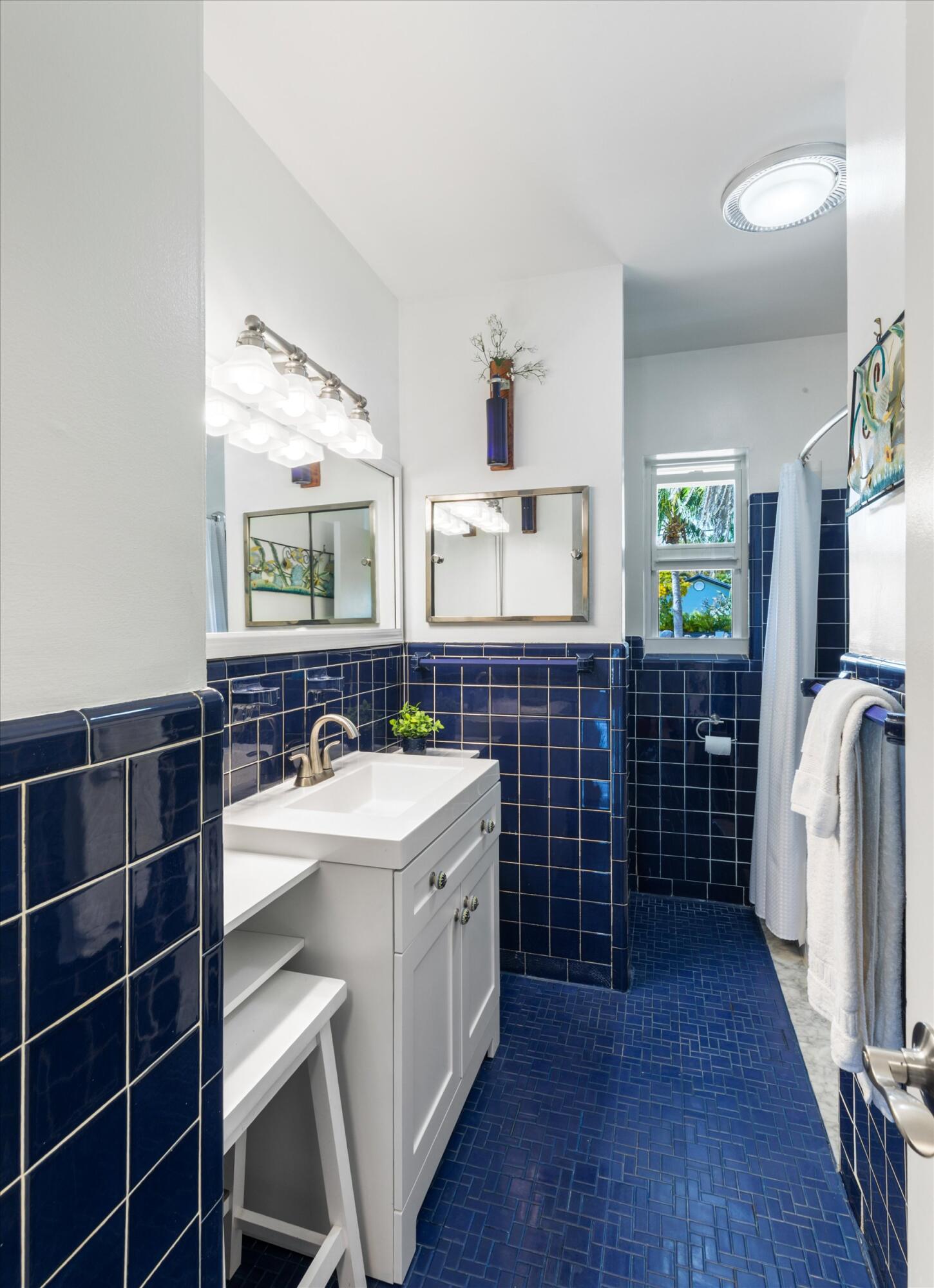 3446 Riviera Drive Key West, FL 33040 - Photo 52 of 73 a bathroom with a double vanity sink a mirror and a bathtub