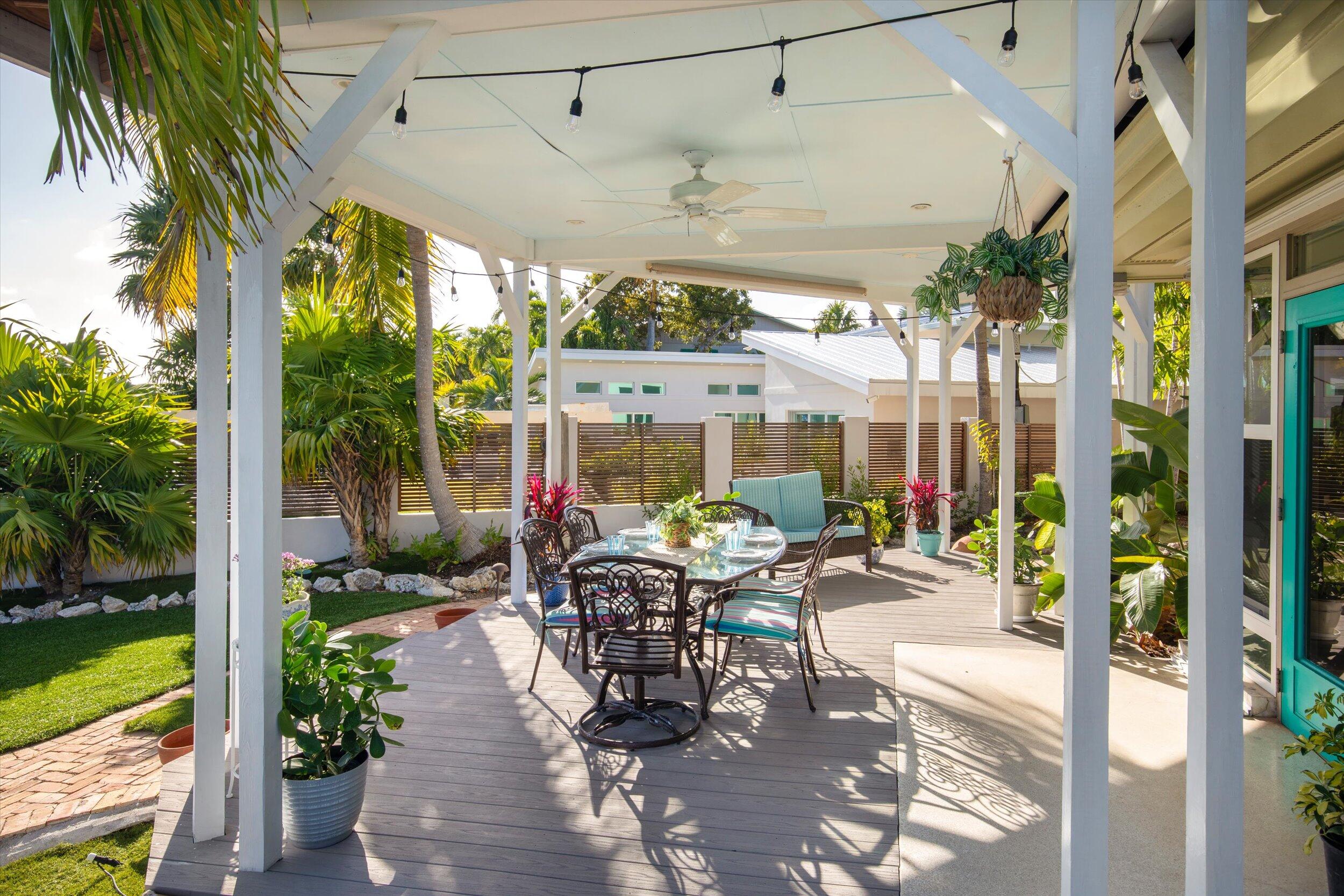 3446 Riviera Drive Key West, FL 33040 - Photo 64 of 73 a patio with yard glass top table and chairs