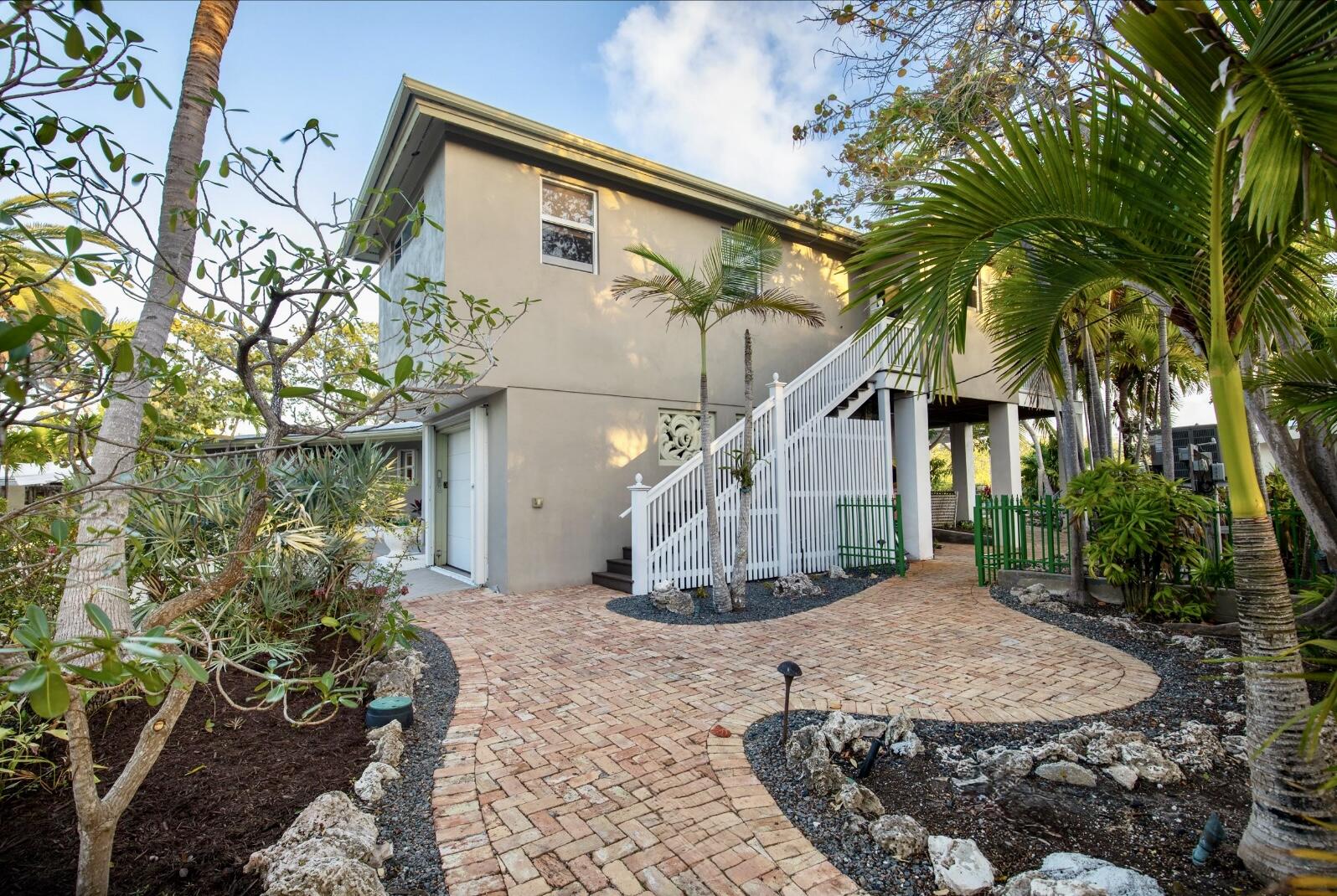 3446 Riviera Drive Key West, FL 33040 - Photo 70 of 73 a front view of a house with a yard