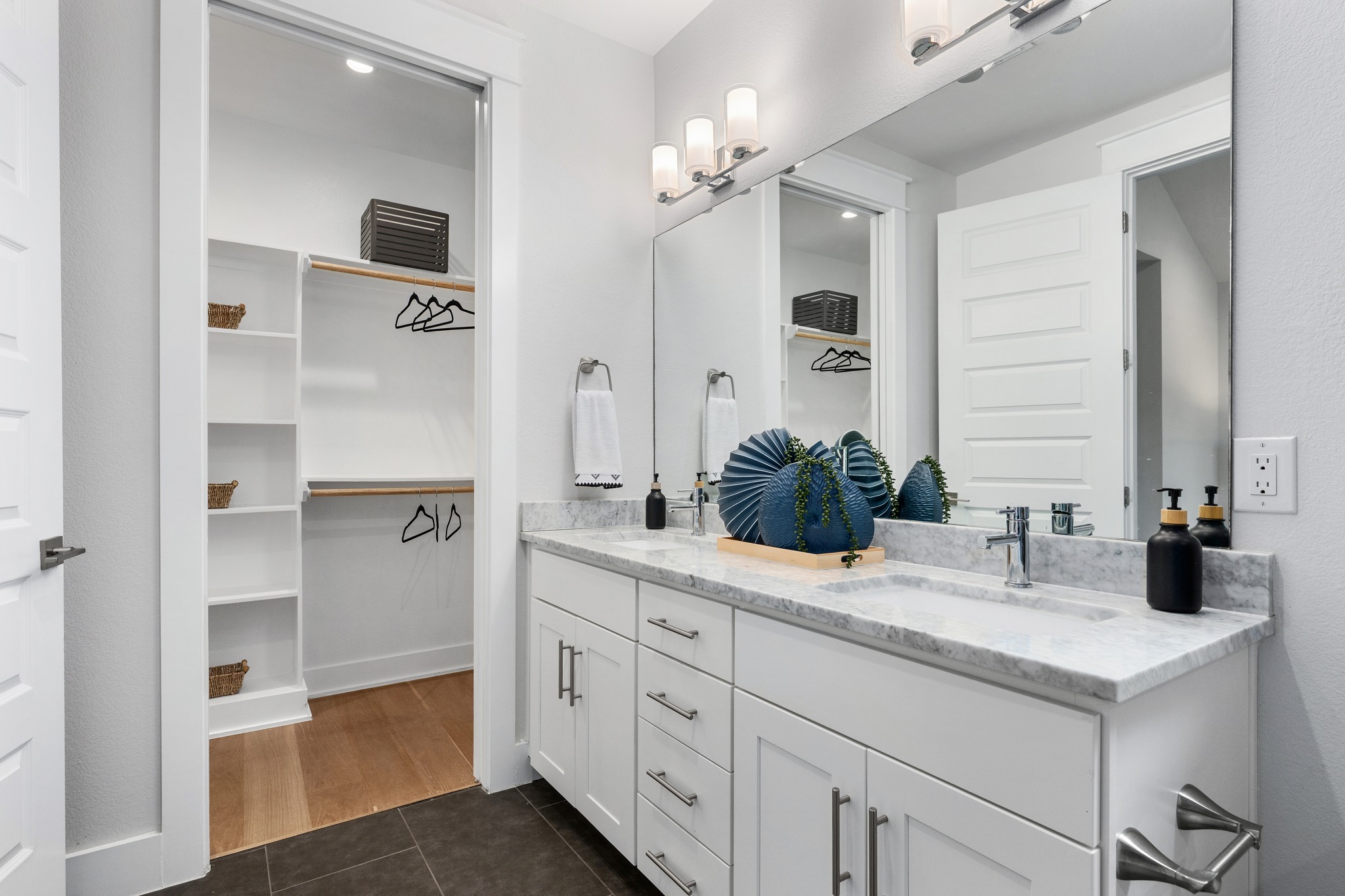 1409 Alegria Road, Unit A Austin, TX 78757 - Photo 16 of 24 Marble-topped double vanity with integrated sinks offers functional elegance in this modern bathroom.