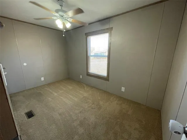 a view of a porch with a table and chairs