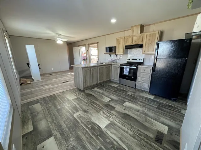 a storage room with wooden floor washer and dryer