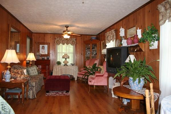 2030 Gentle Road Lewisburg, TN 37091 - Photo 3 of 20 12x27 ft living room, hall on right leading to bath and bedrooms. Built-in bookcases and lamented floors.