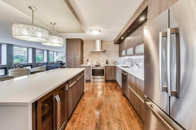 a bathroom with a double vanity sink a toilet a mirror and shower