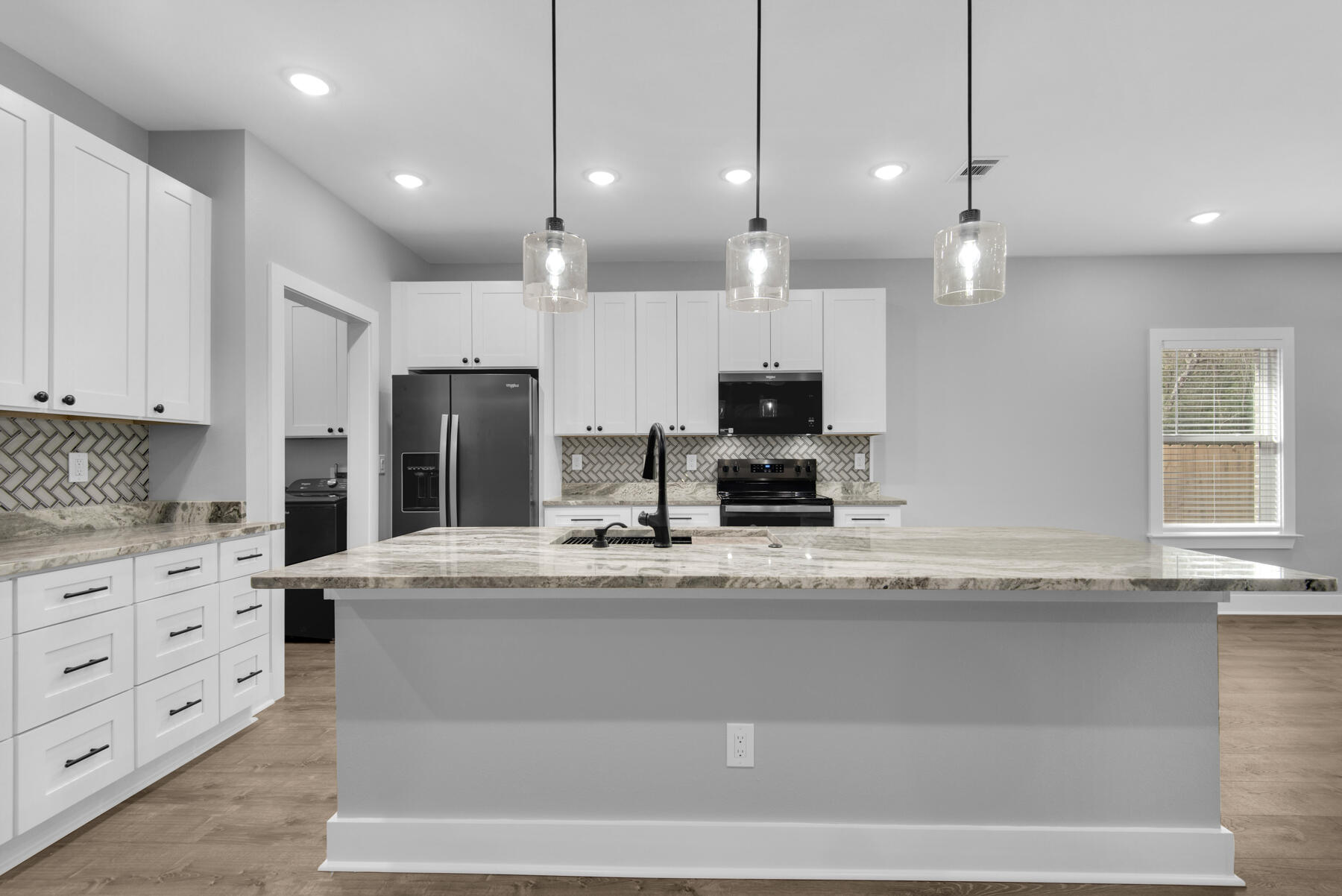 363 Washington Valparaiso, FL 32580 - Photo 12 of 35 a kitchen with stainless steel appliances kitchen island granite countertop a stove a sink and a refrigerator